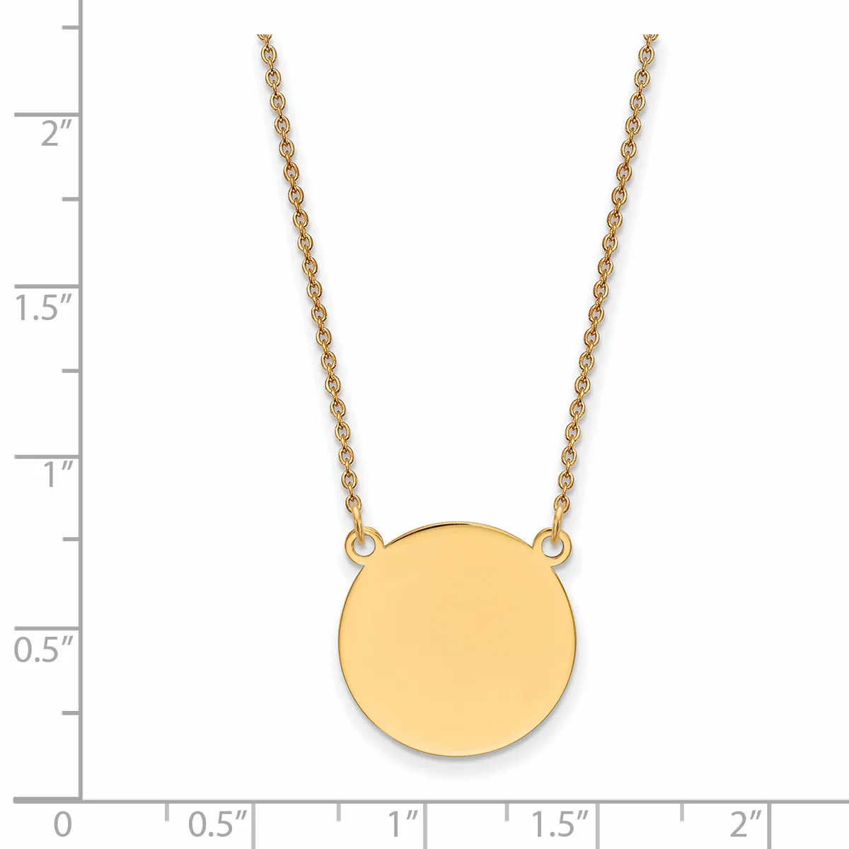 Gold-toned circular pendant necklace with chain, shown against a ruler displaying dimensions up to two inches.