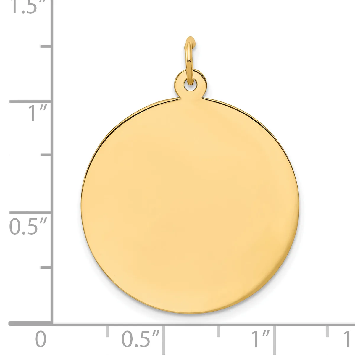 A polished gold-colored circular pendant with a small loop attachment at the top, shown against a ruler measuring approximately one inch in diameter.