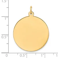 A polished gold-colored circular pendant with a small loop attachment at the top, shown against a ruler measuring approximately one inch in diameter.