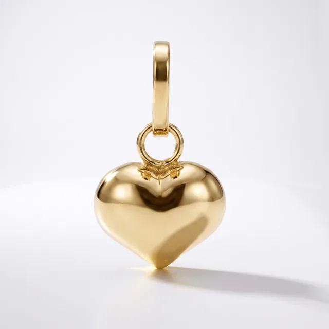 A polished gold heart-shaped pendant with a bail loop attached to the top, displayed against a white background.