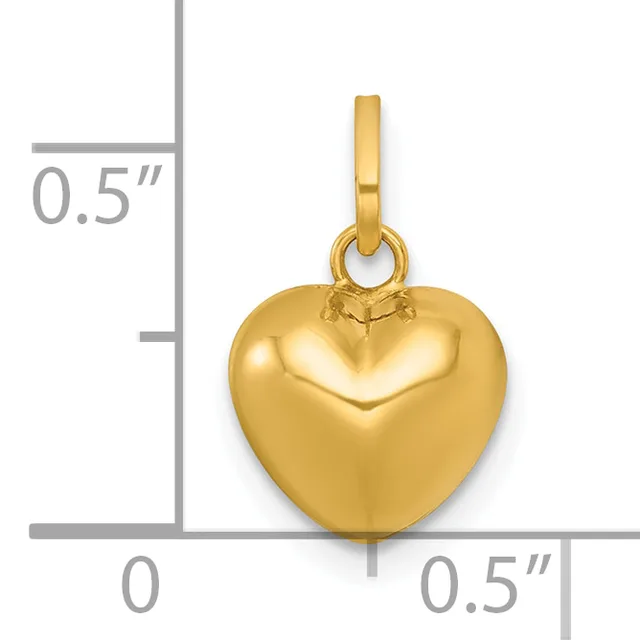 Polished gold-colored heart-shaped pendant with a small loop at the top, shown against a measurement scale indicating approximately 0.5 inches in width and height.