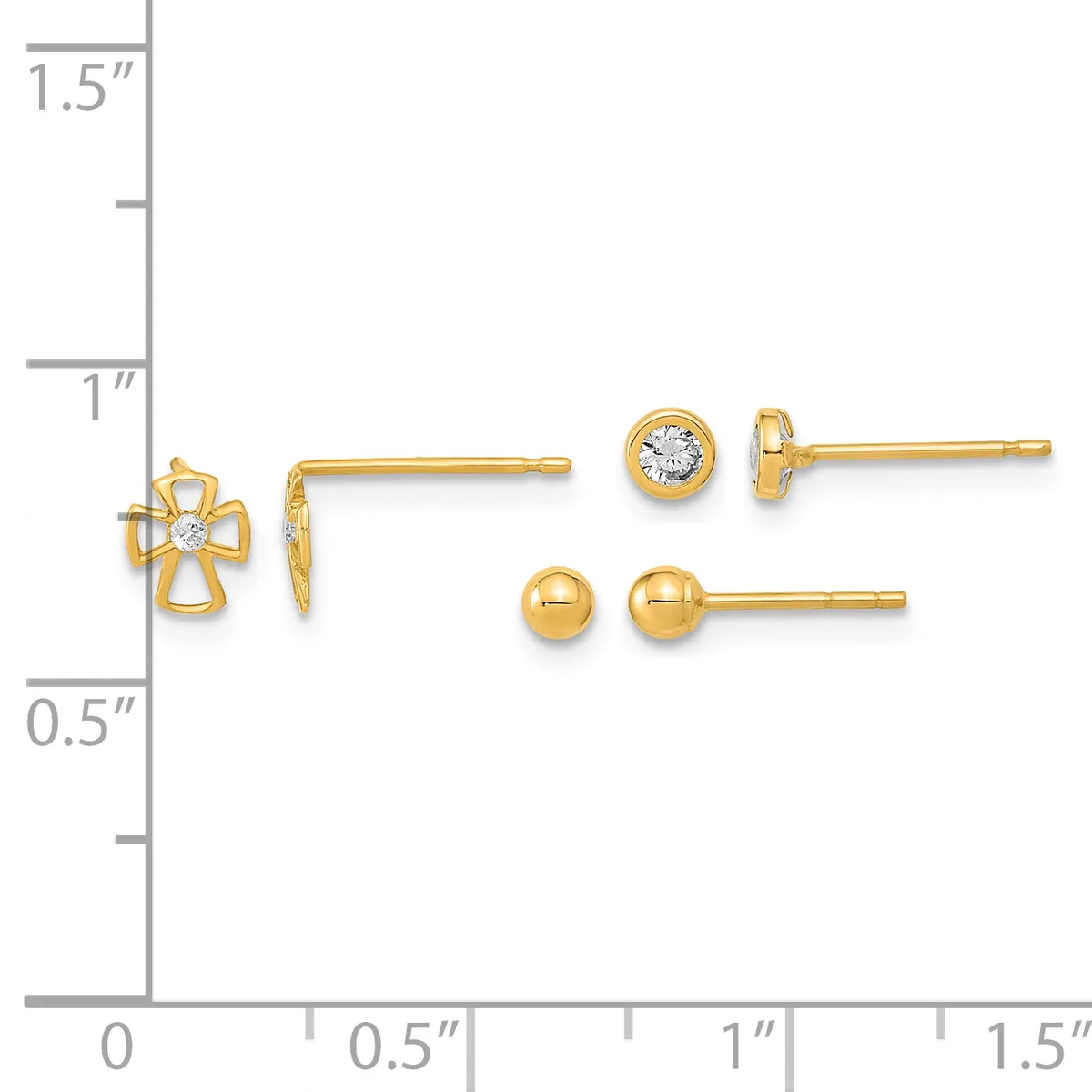Three pairs of gold earrings displayed on a measurement scale: a cross design with a center stone, a round bezel-set stone stud, and a polished ball stud.