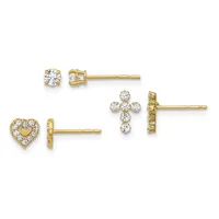 Three pairs of gold stud earrings with cubic zirconia stones arranged in different designs: round solitaire, heart outline, and cross shapes.
