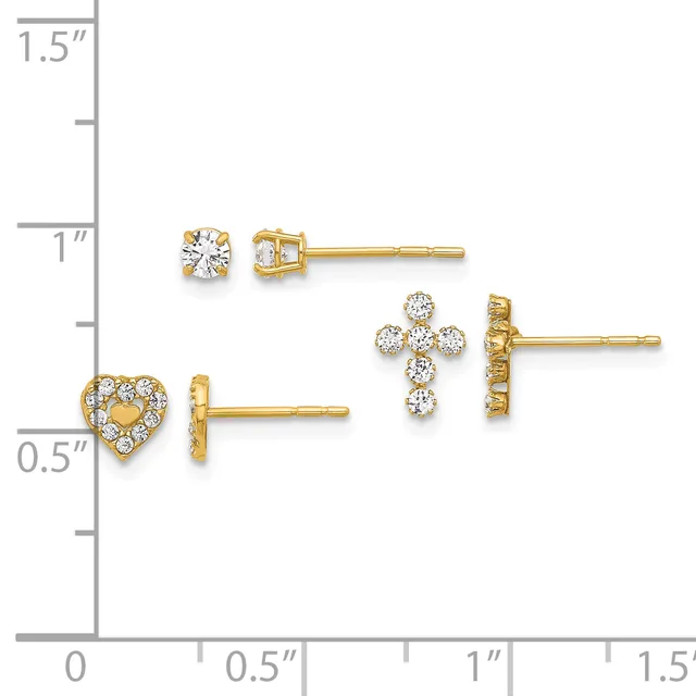 Three pairs of gold stud earrings with cubic zirconia stones displayed on a measurement scale: round solitaire studs, heart-shaped studs with pave stones, and cross-shaped studs with clustered stones.