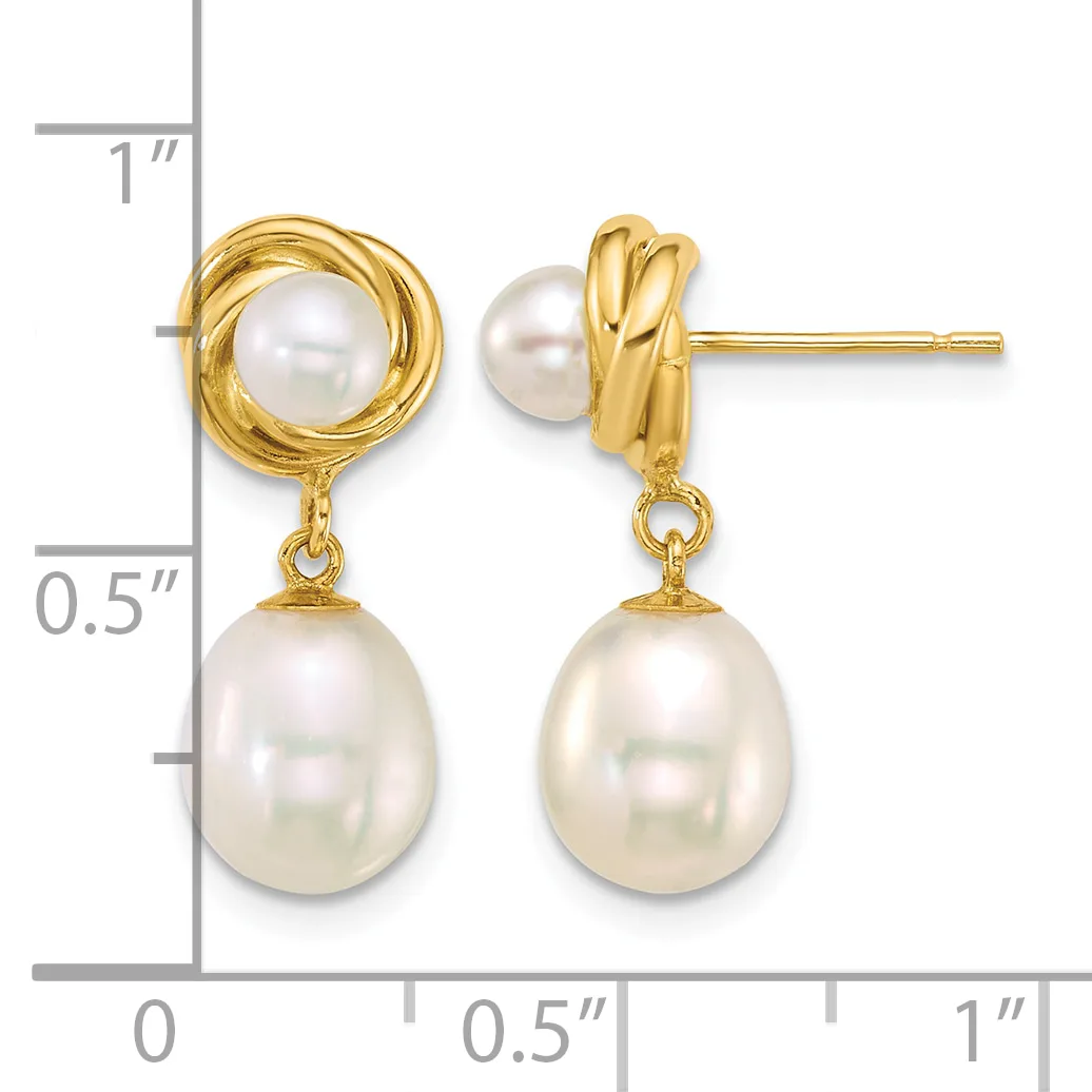 Pair of gold-toned drop earrings with twisted circular tops and dangling oval pearl drops, displayed against a measurement scale.