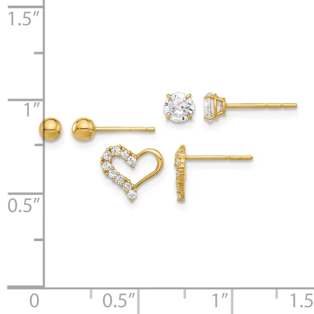 Four pairs of gold earrings displayed on a measurement scale: small polished gold balls, round diamond studs, open heart outline with diamonds, and diamond-accented geometric studs.
