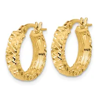 A pair of gold hoop earrings with a textured diamond-cut surface and ribbed interior, displayed against a white background.