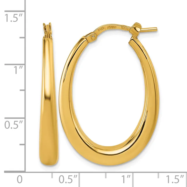 Pair of polished gold-toned oval hoop earrings with a small stamped hallmark, shown next to a ruler indicating approximately one inch in length.