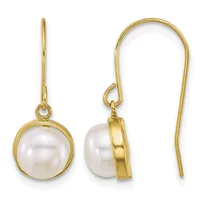 A pair of gold earrings with white pearl drops suspended from curved gold wires, shown from front and side views.