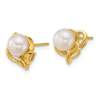Pair of gold stud earrings featuring round white pearls set in decorative gold mountings with curved scrollwork details.