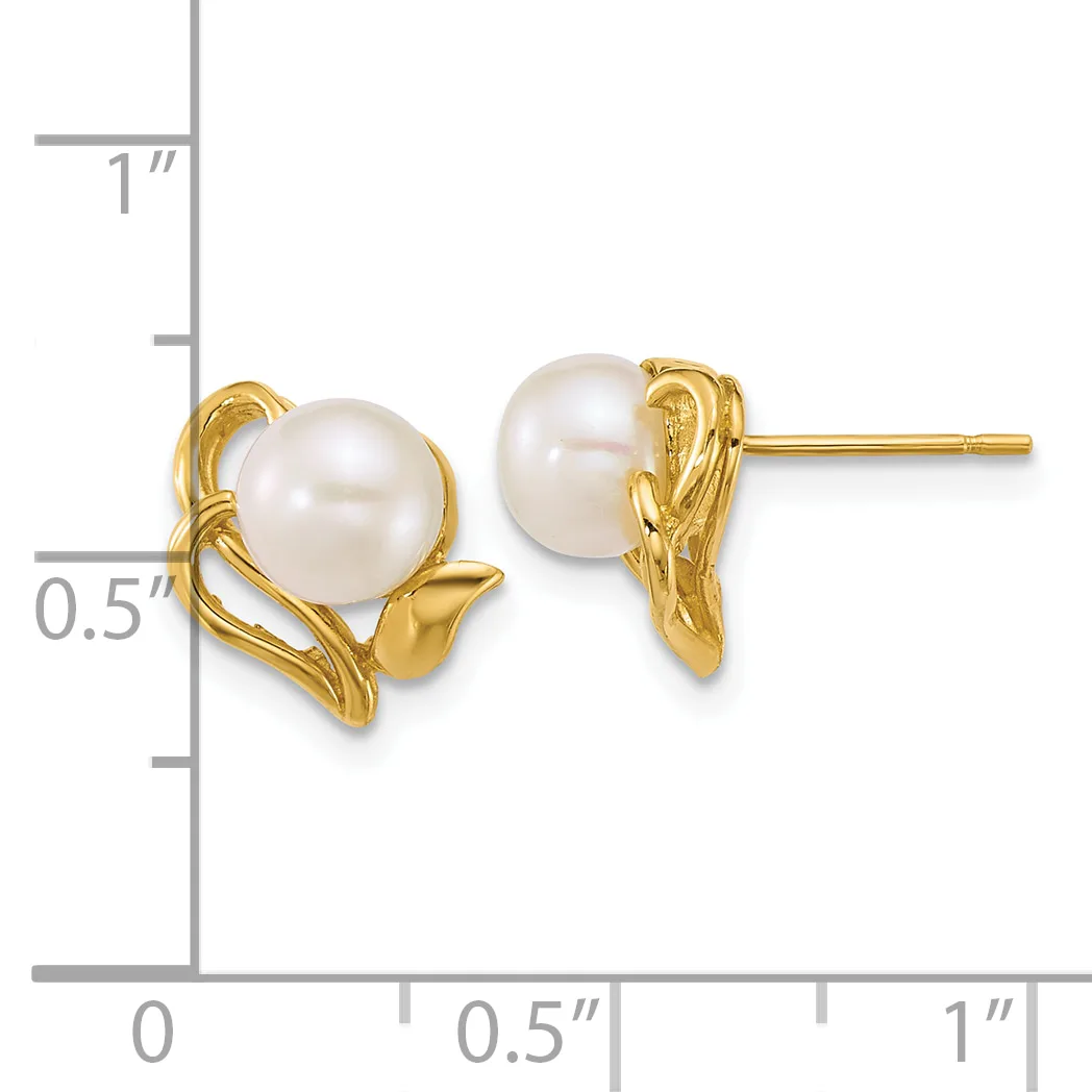 A pair of gold stud earrings with white pearl centers surrounded by twisted gold metalwork, displayed against a measurement scale.