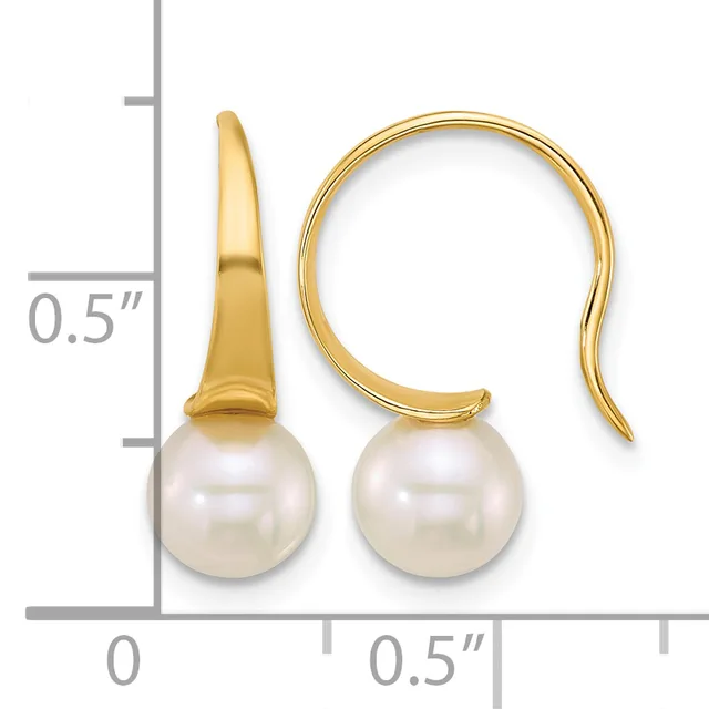 A pair of gold fishhook earrings with white pearl drops, shown next to a ruler indicating approximately half-inch length.
