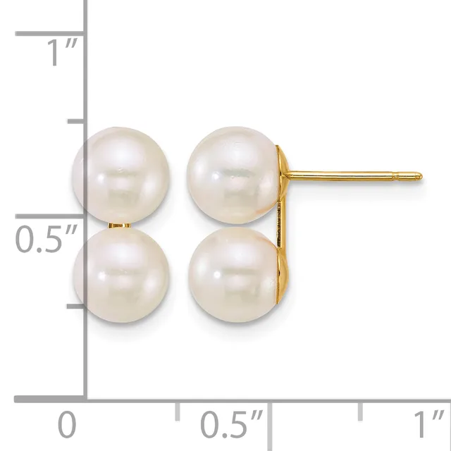 A pair of white pearl stud earrings with gold posts and backs, displayed against a ruler showing the earrings are approximately 0.5 inches tall.