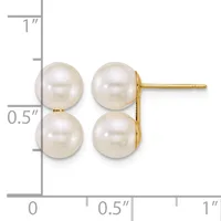 A pair of white pearl stud earrings with gold posts and backs, displayed against a ruler showing the earrings are approximately 0.5 inches tall.