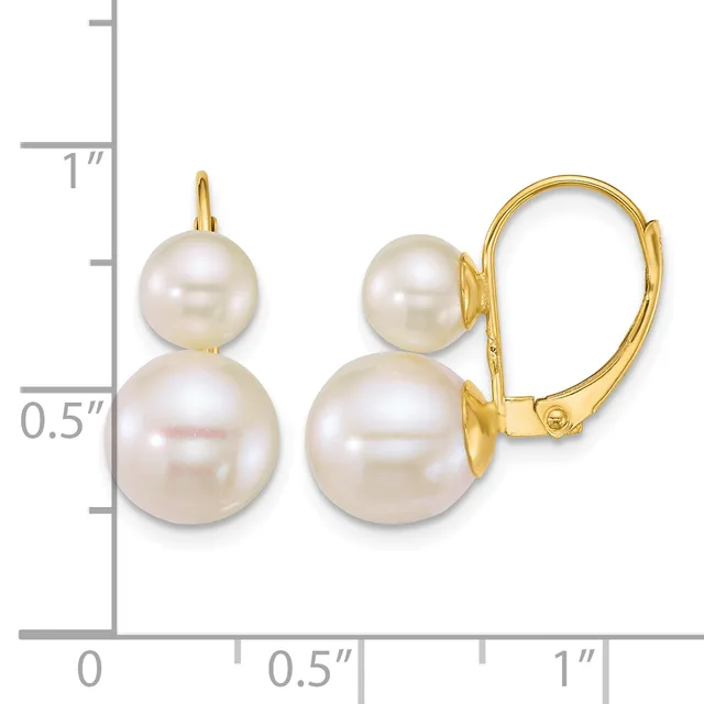 A pair of gold leverback earrings, each featuring two graduated white pearls stacked vertically, displayed against a measurement scale.