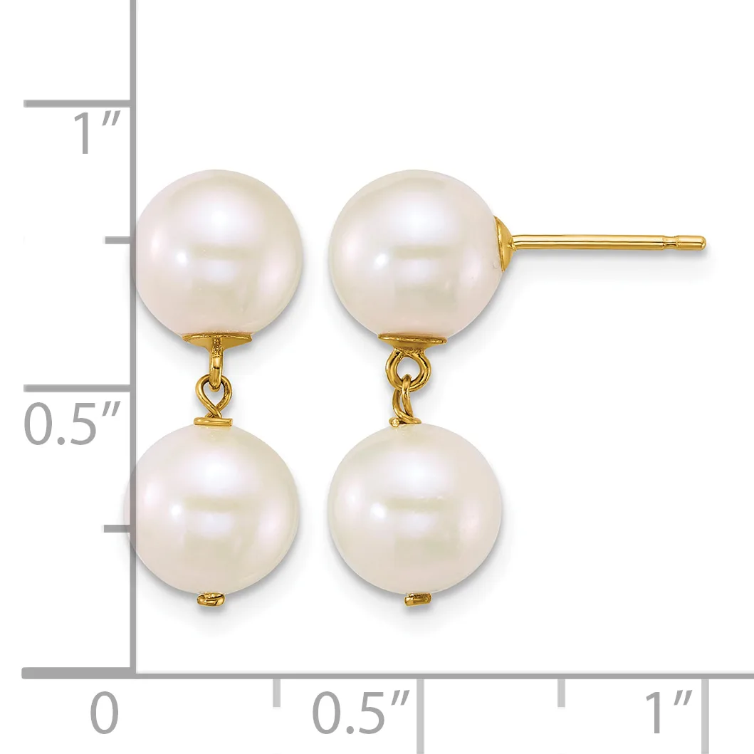 Pair of gold earrings with two white pearl drops suspended from studs, shown against a ruler measuring approximately one inch in length.