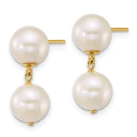 Pair of gold earrings with round white pearl studs on top and larger round white pearls hanging below, connected by small gold links.