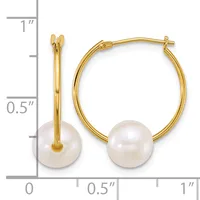 Gold hoop earrings with white pearl drops, shown next to a ruler indicating approximately one inch in length.