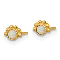 Pair of gold stud earrings with bezel-set round opal cabochons surrounded by decorative beaded borders.