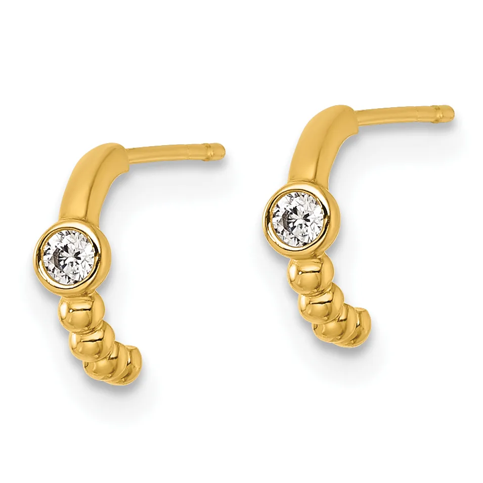 A pair of gold curved drop earrings with bezel-set round diamonds and textured lower sections, shown against a white background.