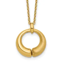 Gold circular pendant with a split design, one side polished and one side textured, hanging from a gold chain.