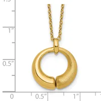Gold circular pendant with a polished and textured finish, suspended from a gold chain, displayed against a measurement scale.