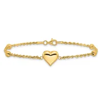 Gold-toned bracelet with a twisted rope chain design, a polished puffy heart charm in the center, and a lobster claw clasp, displayed against a white background.