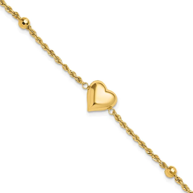 Gold-toned bracelet with a twisted chain design, featuring a polished heart charm in the center and small spherical beads at each end.