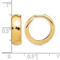 A pair of polished gold hoop earrings with a textured hammered surface, displayed next to a ruler showing they measure approximately one inch in height.