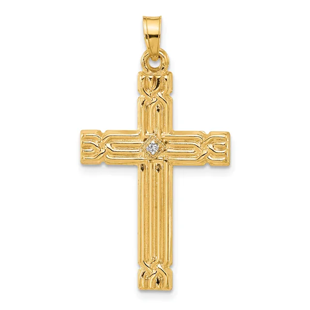 Gold cross pendant with vertical ribbed design, decorative curved elements on the horizontal bar, and a small diamond or crystal stone at the center intersection.