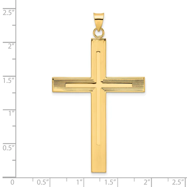 A gold cross pendant with vertical ridged texture and horizontal crossbar, shown against a measurement scale indicating approximately 2.5 inches in height.