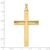 A gold cross pendant with vertical ridged texture and horizontal crossbar, shown against a measurement scale indicating approximately 2.5 inches in height.