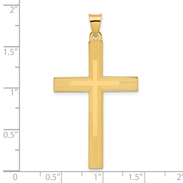 A gold cross pendant with textured surface and bail loop, shown against a ruler measuring approximately 1.9 inches in height and 1 inch in width.