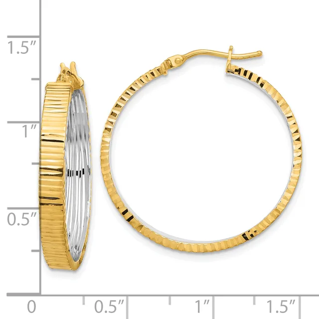 Two-tone gold hoop earrings with textured ridged surface and post-and-clutch closures, displayed next to a measurement ruler showing approximately one-inch diameter.
