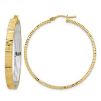 A pair of two-tone gold hoop earrings with textured ridged surfaces and white gold accents on the inner edges, shown from front and side views.