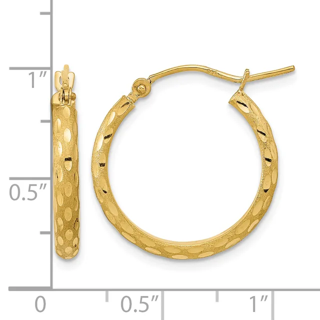 Gold textured hoop earrings with a hammered finish and hinged posts, shown next to a ruler measuring approximately one inch in diameter.