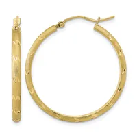 A pair of gold hoop earrings with a textured diamond-cut surface and hinged closures, shown from front and side views.