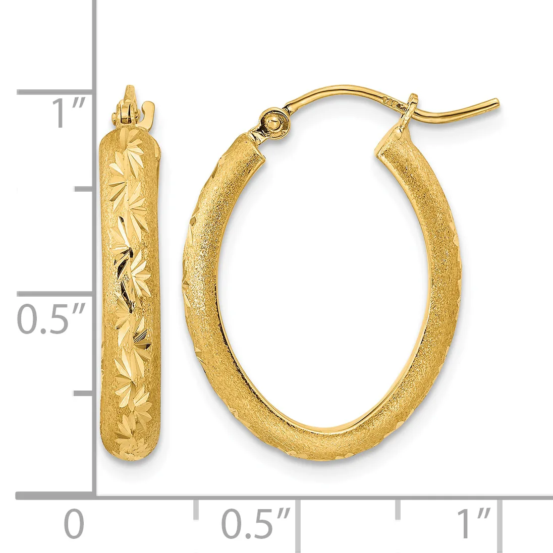 A pair of gold oval hoop earrings with textured surfaces and etched leaf designs, displayed next to a ruler showing approximately one inch in length.