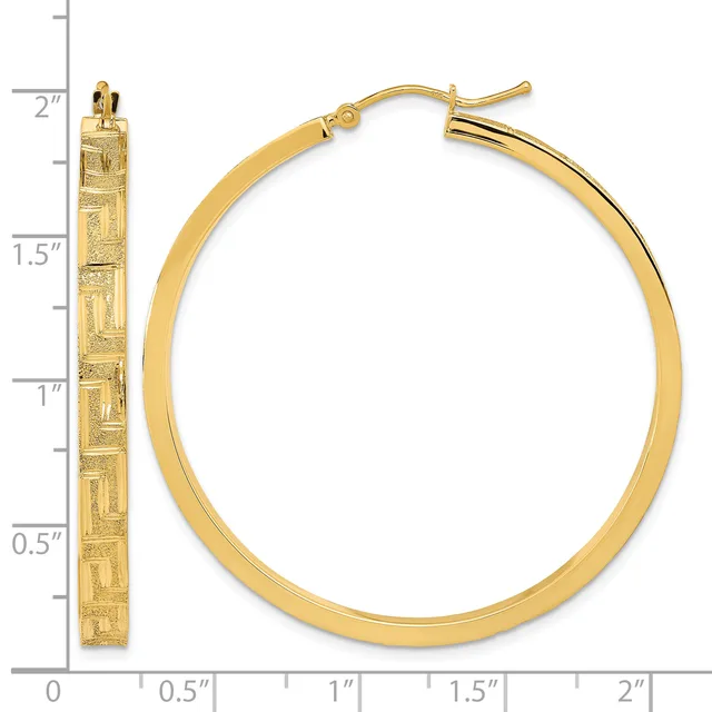 Gold-toned hoop earrings with a textured rectangular pattern on the front surface, displayed next to a measurement ruler showing approximately two inches in length.