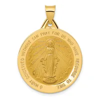 Gold-toned round pendant with a religious figure in the center surrounded by radiating lines, with text around the outer edge and a small stamped hallmark at the bottom.