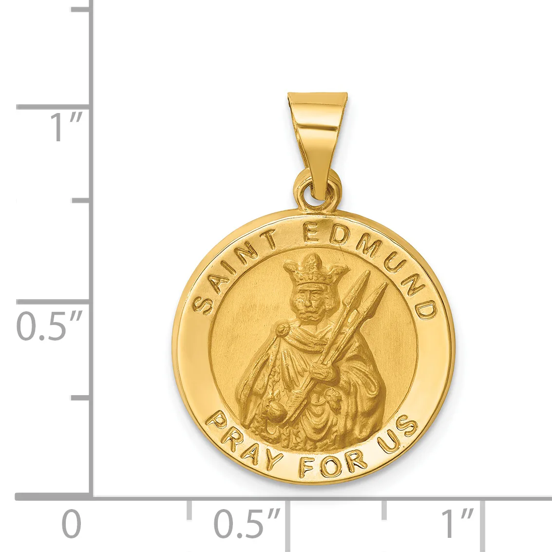 Gold-colored round pendant with a relief image of Saint Edmund holding a sword and arrow, surrounded by text reading "Saint edmund" and "Pray for us," shown next to a ruler for scale.