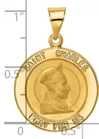 Gold round pendant featuring a profile portrait of Saint Charles with text around the border, shown next to a ruler for scale.