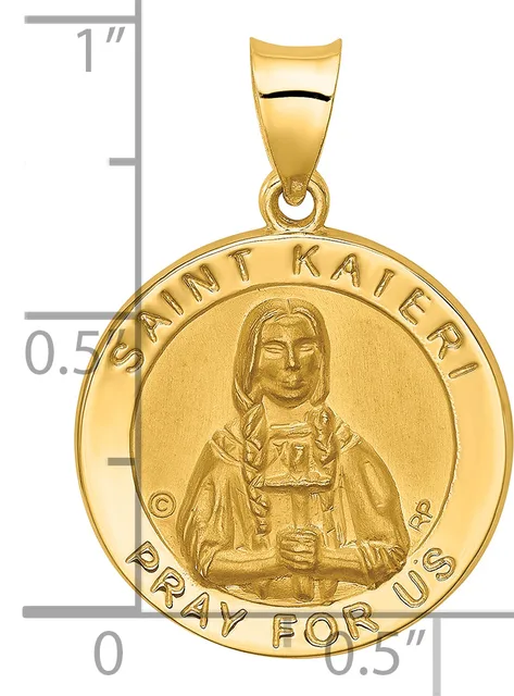Gold round pendant featuring a portrait of Saint Kateri with text around the border, shown next to a ruler indicating approximately one inch in diameter.