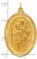 Gold oval pendant featuring Saint Christopher carrying Christ child, with decorative beaded border and loop bail, shown against a measurement scale.