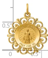 Gold-colored ornate round pendant with decorative scrollwork border featuring an infant figure with radiating lines and text around the rim, with a small stamped hallmark visible.