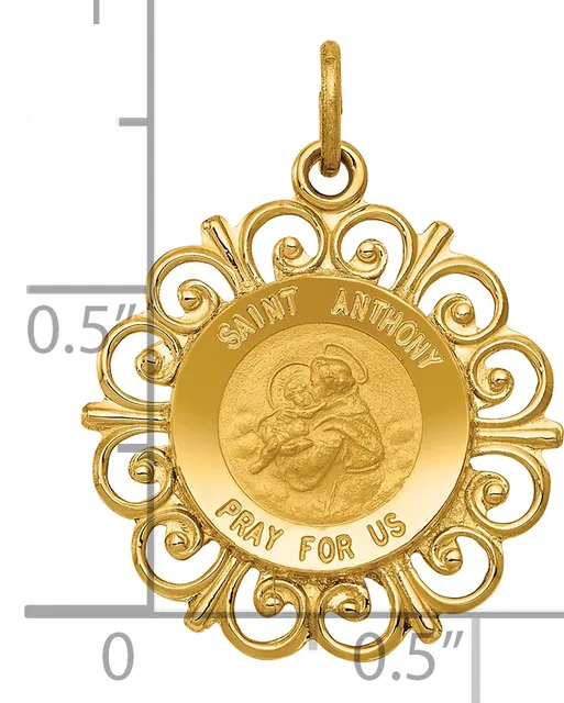 Gold-colored ornate circular pendant with scalloped filigree border featuring Saint Anthony holding a child, with text around the rim, shown with a measurement scale.