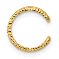 Gold-toned open cuff bracelet with a textured surface featuring repeating diagonal ridges along the entire band.