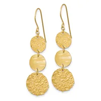 Pair of gold dangle earrings with three stacked circular discs each, alternating between textured and smooth finishes, suspended from curved ear wires.
