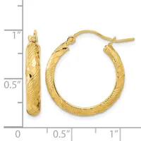 A pair of textured gold hoop earrings with a diagonal quilted pattern, shown next to a measurement scale indicating they are approximately one inch in diameter.