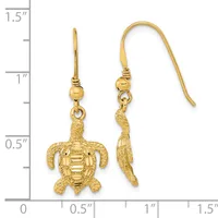 Gold sea turtle dangle earrings with textured shells and smooth fins, shown on a measurement scale indicating approximately one inch in length.